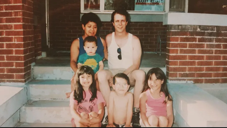 The family on the front steps of a brick house