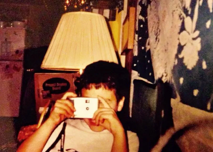 As a kid, holding a camera up to take a picture